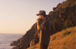 Man by the ocean drinking a cup of medicinal mushrooms