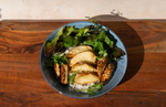 Wooden Board with a bowl of food containing Lion's Mane Mushroom, rice and salad