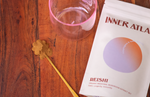 Reishi medicinal mushroom powder, a golden spoon and a tea cup to make a Reishi tonic tea